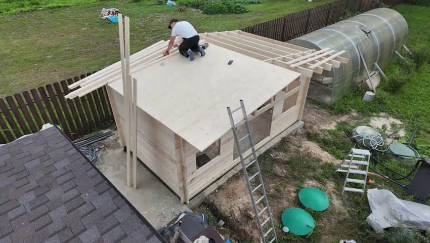 На этом фото виден широкий свес крыши спереди хозблока — он дает тень в жару, а еще с ним на окна и двери попадает меньше дождя